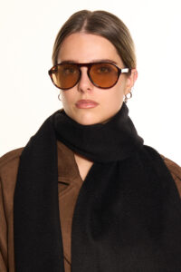 A black cashmere scarf elegantly folded in a signature box.