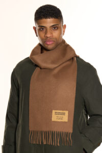 A folded plaid cashmere scarf in a high-quality gift box.