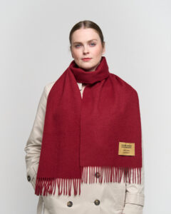 An elegant lifestyle shot of a woman in Shanghai wearing a classic Scottish check scarf, blending Eastern and Western aesthetics.