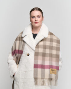 A couple sharing a cosy winter moment, each wearing an Edinburgh Lambswool scarf