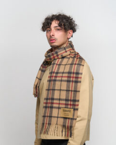 A close-up of an iconic red tartan cashmere scarf, symbolising prosperity and Scottish tradition.